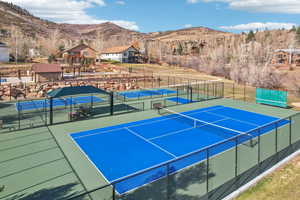 View of tennis court with a mountain view