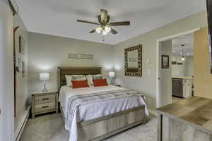 Bedroom featuring a baseboard radiator, brand new carpet, and a ceiling fan
