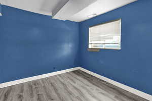 Empty room with wood finished floors and baseboards
