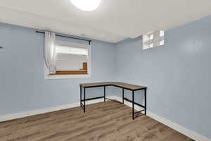 Unfurnished room featuring wood finished floors and baseboards