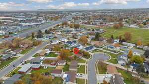 Aerial view of property's location featuring nearby suburban area and a mountainous background