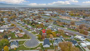 Aerial overview of property's location with mountains and nearby suburban area