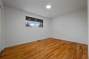 Unfurnished room featuring light wood-style floors and baseboards