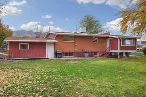 Back of house featuring a chimney, brick siding, and a mountain view