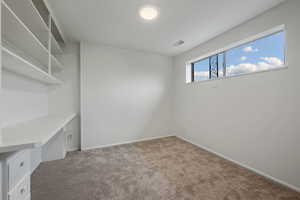 Interior space with light carpet and baseboards