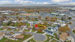 Aerial overview of property's location featuring mountains and nearby suburban area