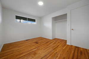 Unfurnished bedroom featuring light wood-type flooring and a closet