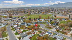 Aerial view of property's location featuring nearby suburban area and mountains