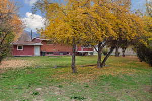 View of green lawn featuring a mountain view