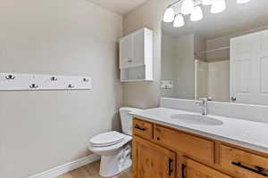 Bathroom with vanity, a shower, and light wood finished floors