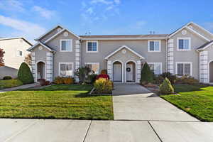 View of front of home with stucco siding and a front yard