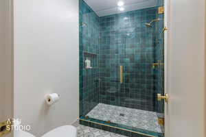 Full bath with a shower stall and toilet