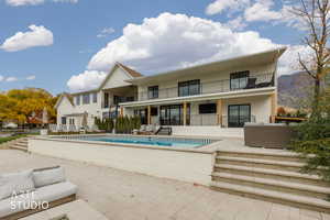 View of pool with a patio area and stairway