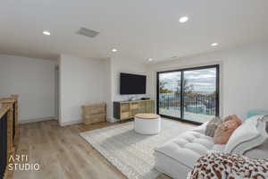 Living area featuring recessed lighting and light wood-style flooring