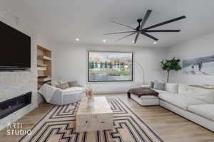Living area featuring light wood-style flooring, a stone fireplace, recessed lighting, and ceiling fan