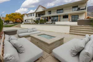 View of patio featuring an outdoor living space with a fire pit and stairs