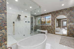 Full bath featuring a freestanding tub, recessed lighting, a marble finish shower, wallpapered walls, and vanity