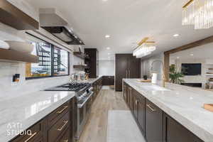 Kitchen with light stone counters, dark brown cabinetry, open shelves, double oven range, and light wood-style floors