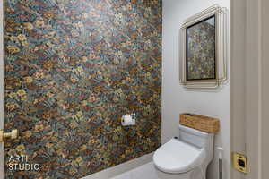 Bathroom with toilet and baseboards