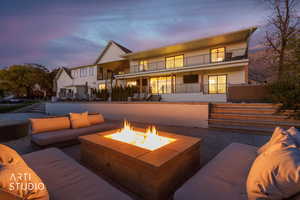 Patio terrace at dusk with a patio area and a balcony