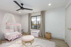 Bedroom with wood finished floors, recessed lighting, and a ceiling fan