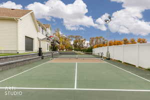 View of tennis court with a residential view and private basketball court