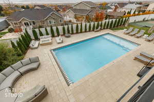 View of pool with a patio area, a fenced backyard, and a residential view