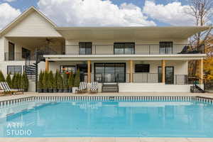 Rear view of property with an secluded outdoor pool and seating area