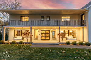 Front view of property featuring outdoor lounge area, a yard, brick siding, and a patio