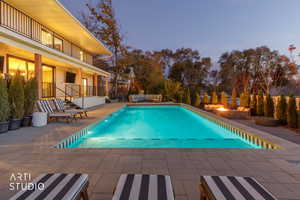 View of pool with a patio, an outdoor hangout area, and a balcony