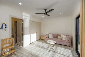 Living area with recessed lighting and ceiling fan
