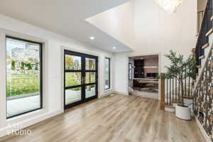 Entrance foyer with stairs, healthy amount of natural light, recessed lighting, and light wood-style floors