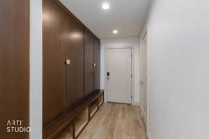 Hallway featuring light wood-type flooring and recessed lighting