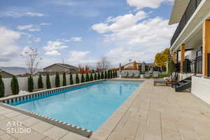View of pool featuring a patio area and a fenced backyard