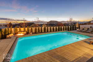 View of pool featuring a fenced backyard, a patio area, and a fire pit