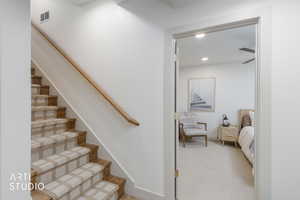 Stairway featuring carpet and recessed lighting