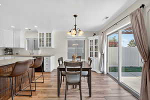 Dining area featuring a chandelier, light wood finished floors, and recessed lighting