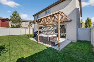 Back of house with stucco siding, a fenced backyard, an outdoor living space, and a pergola