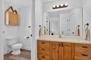 Bathroom with light wood-style flooring and vanity