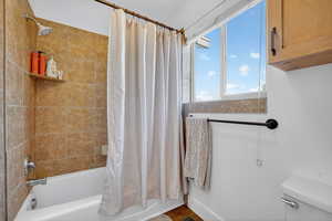 Full bath featuring shower / tub combo and toilet