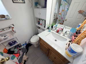 Bathroom with curtained shower and vanity