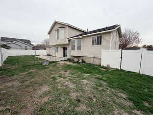 Back of property featuring a fenced backyard