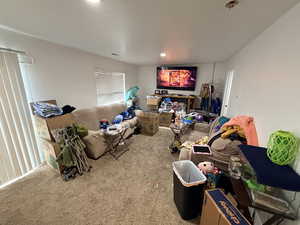 Carpeted living area with recessed lighting