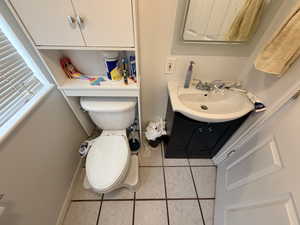 Bathroom featuring light tile patterned flooring and vanity