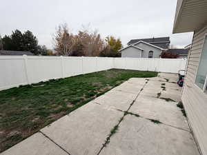 Fenced backyard with a patio area