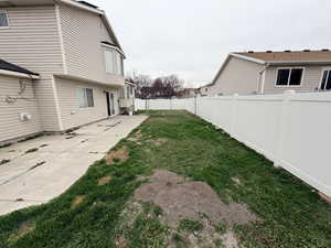 Fenced backyard featuring a patio