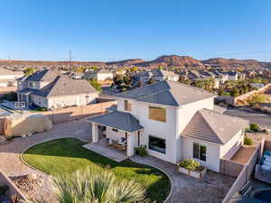 Back of property with a residential view, a fenced backyard, stucco siding, and a patio area
