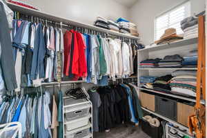 Spacious closet featuring dark wood-type flooring