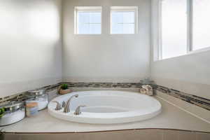 Full bathroom with a bath and healthy amount of natural light