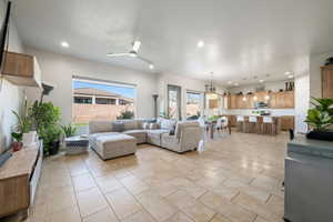 Living area with light tile patterned floors, recessed lighting, and a ceiling fan
